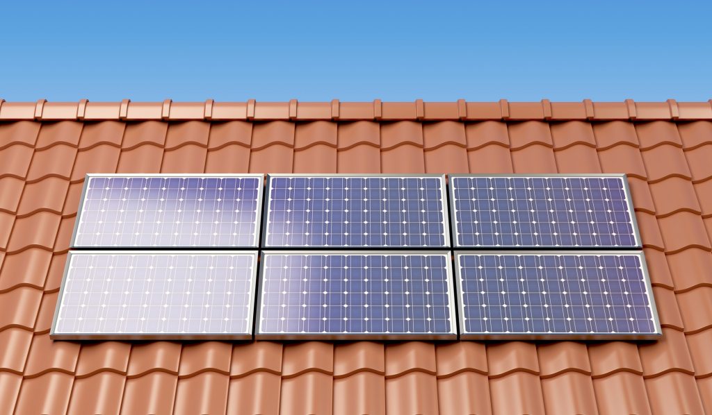 Solar panels on the roof of a house, producing electricity